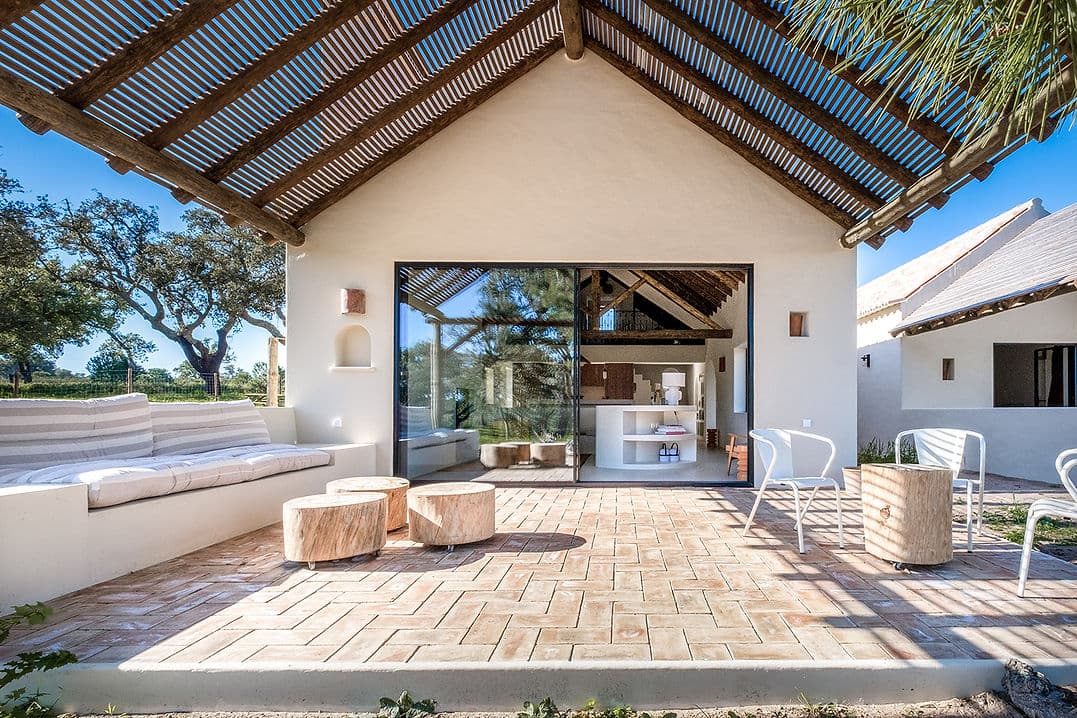 Outdoor terrace with seating and rustic pergola at Rafter Melides Serena in Melides, Portugal