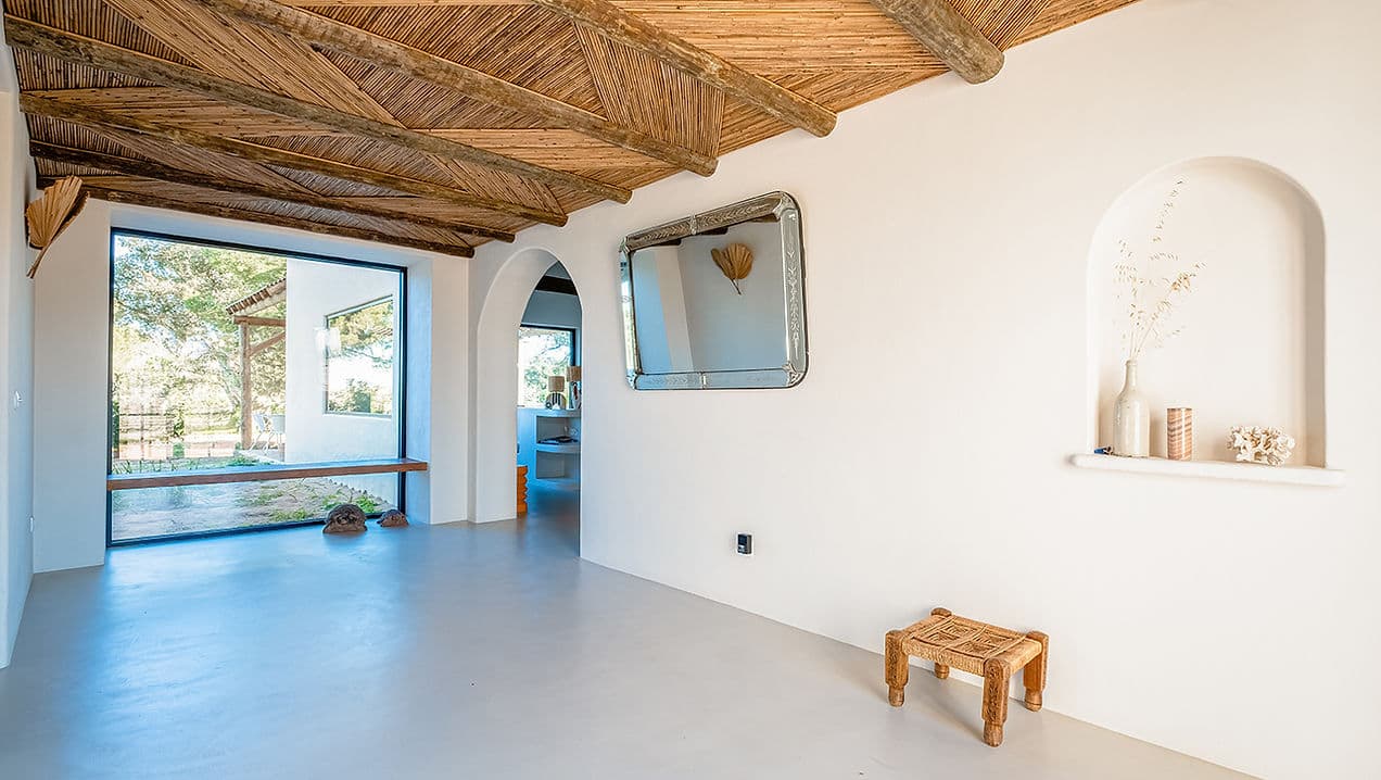 Spacious living area with large window and wooden ceiling at Rafter Melides Serena in Melides, Portugal