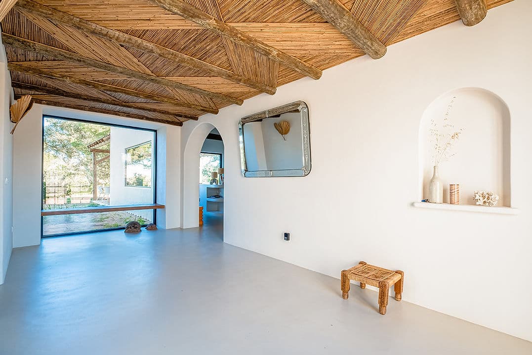 Spacious living area with large window and wooden ceiling at Rafter Melides Serena in Melides, Portugal