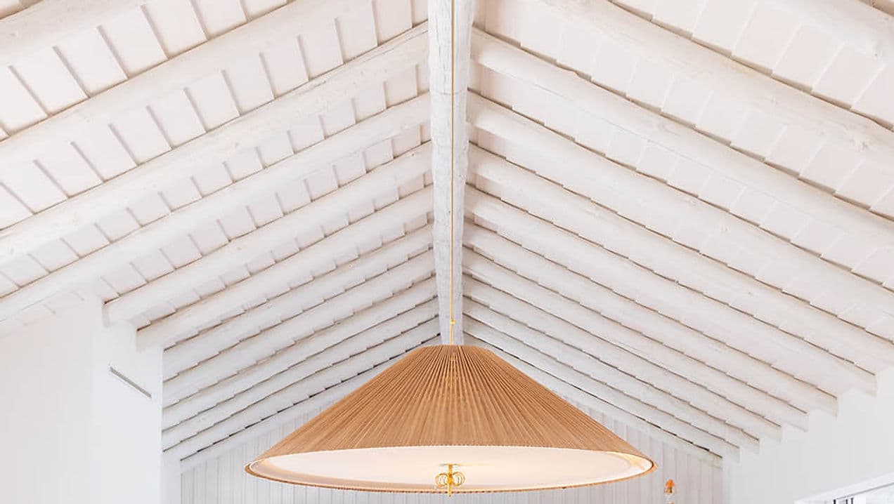 White vaulted ceiling with exposed beams and large rattan pendant light at Casa AHA at Casa AHA!, Carvalhal / Comporta