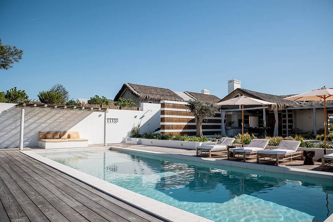 Outdoor pool area with sun loungers and umbrellas at Casa AHA at Casa AHA!, Carvalhal / Comporta