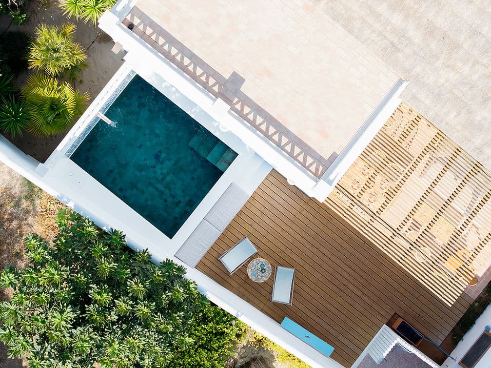 Private pool and sun terrace surrounded by lush greenery at Casa Mounette in Portugal