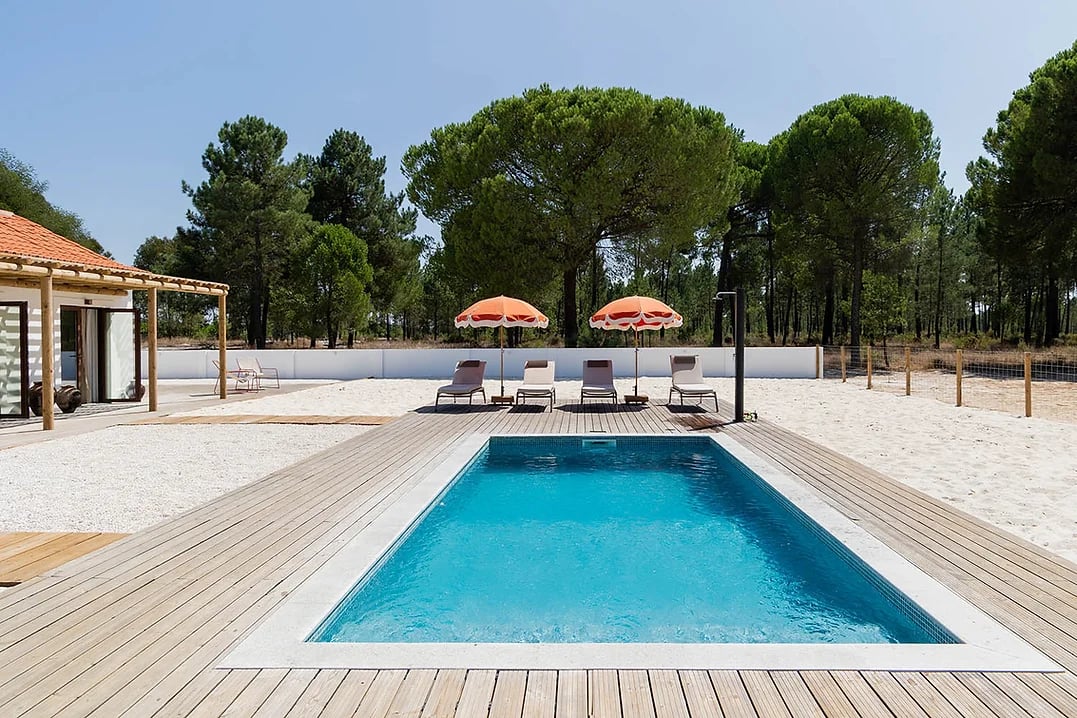 Outdoor swimming pool with sun loungers and umbrellas at Rafter Carvalhal Bicas, Carvalhal, Portugal