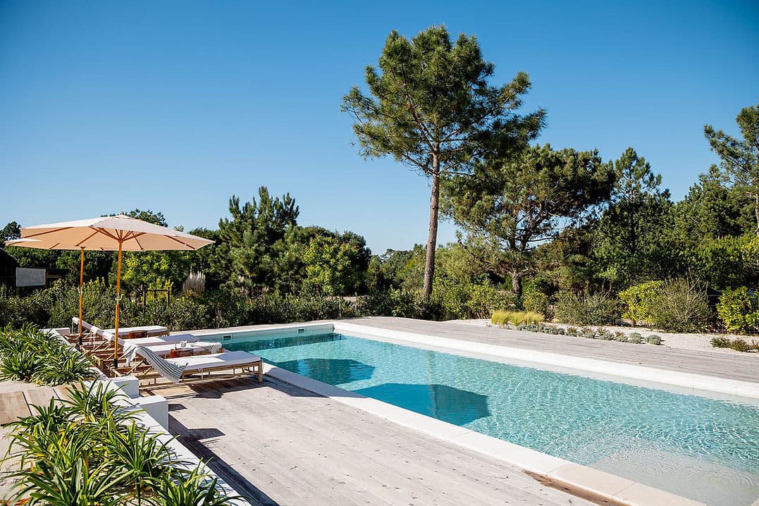 Outdoor swimming pool with lounge chairs and umbrellas at Casa AHA at Casa AHA!, Carvalhal / Comporta