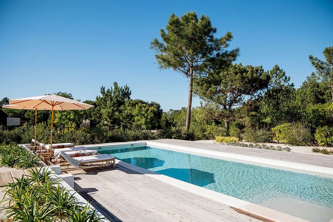 Outdoor swimming pool with lounge chairs and umbrellas at Casa AHA at Casa AHA!, Carvalhal / Comporta