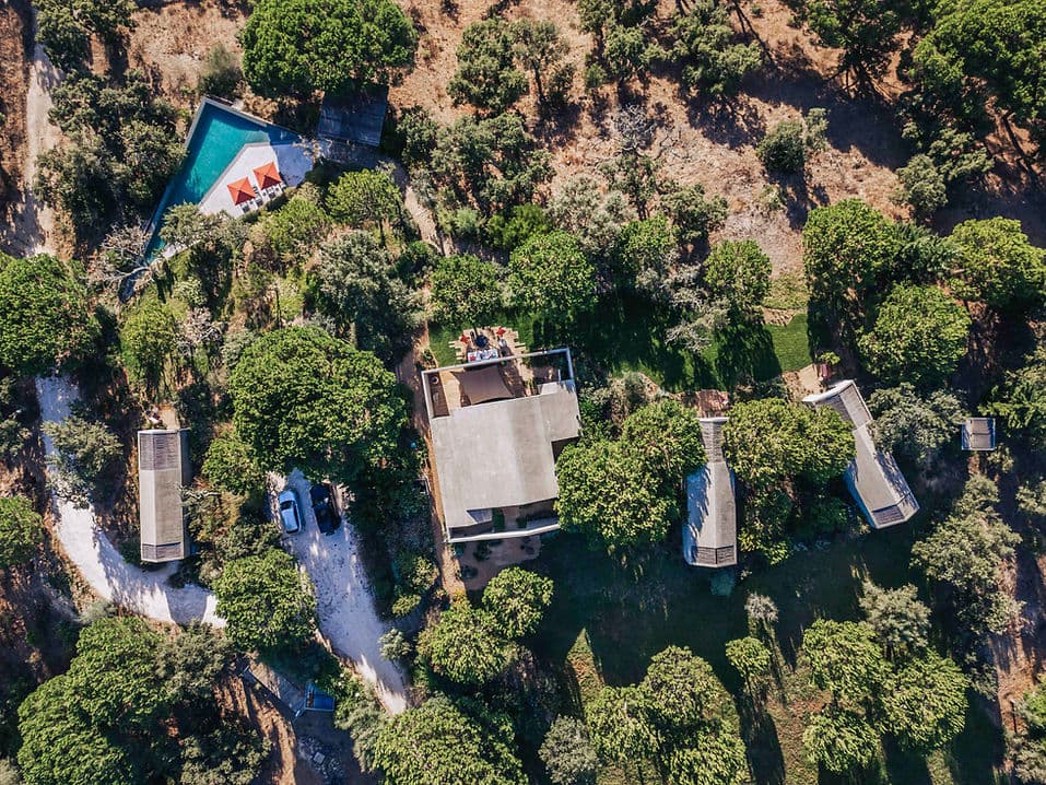 Aerial view of Rafter Melides Atlantica showing multiple buildings, shaded outdoor seating, and pool in Melides, Portugal