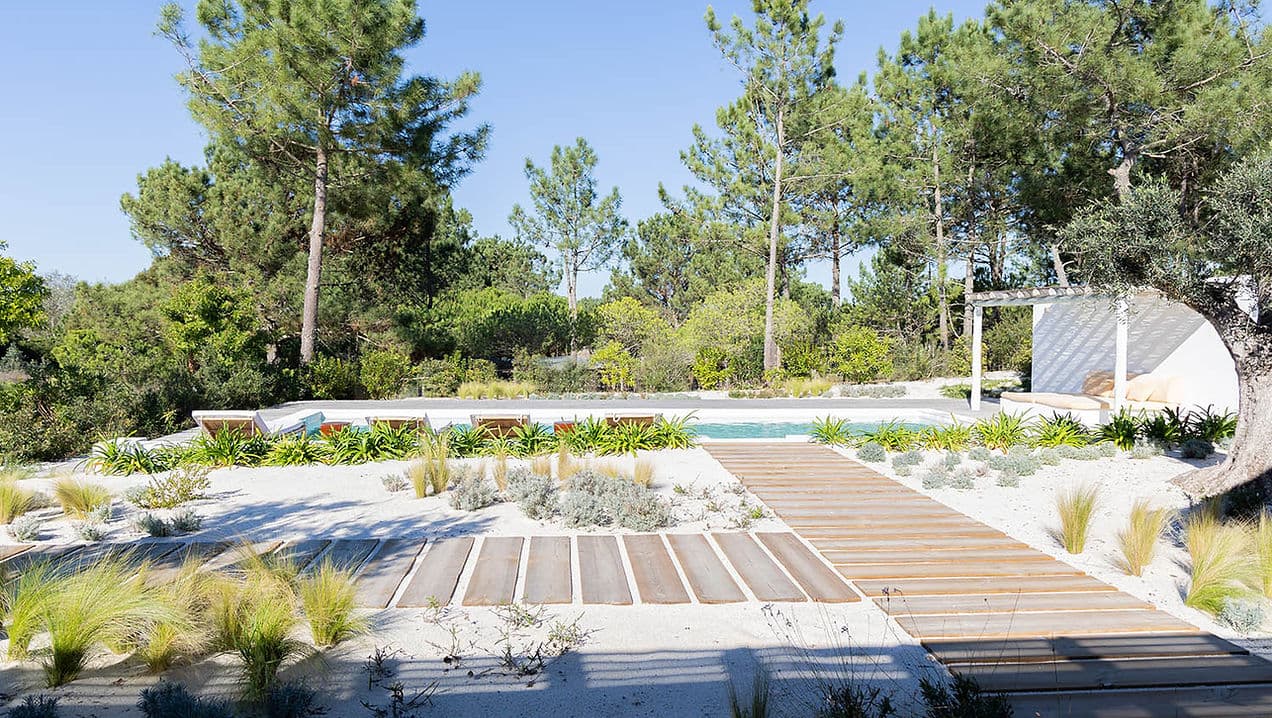Outdoor pool area with sun loungers and wooden walkway at Casa AHA at Casa AHA!, Carvalhal / Comporta
