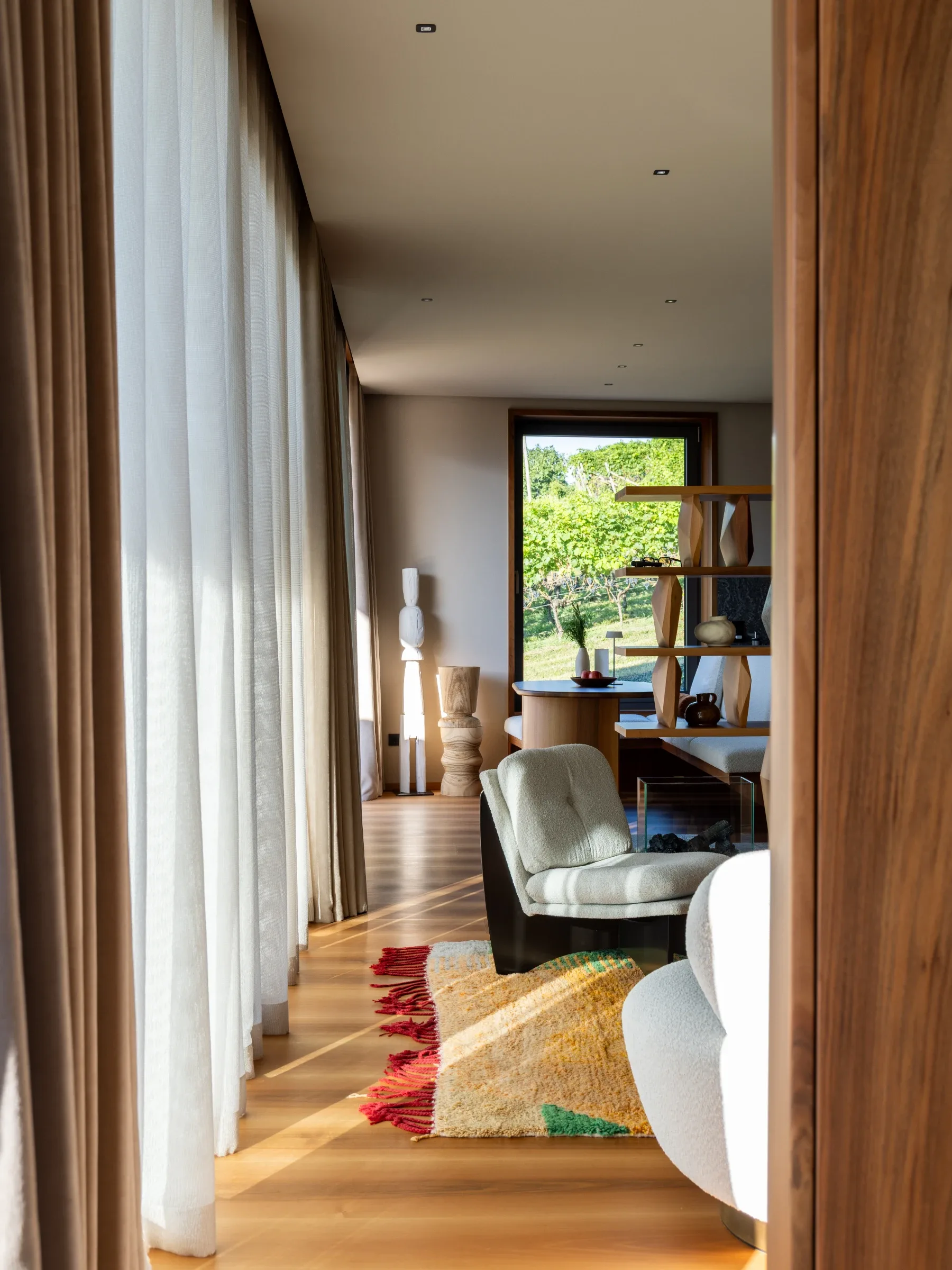 Living room at Rafter Merano Algund with modern furniture and vineyard view in Algund, Italy