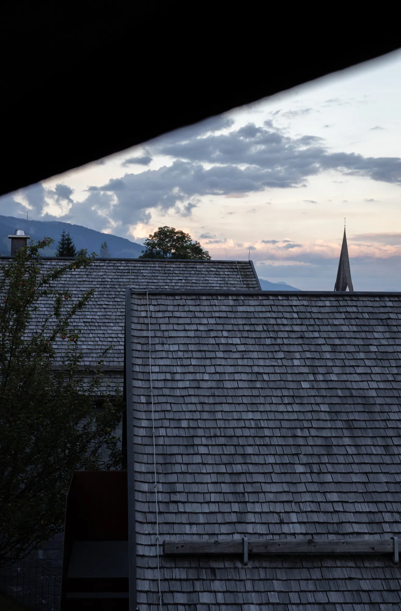 Sloped shingle roofs and distant mountain view at Rafter Bramberg in Bramberg am Wildkogel, Austria