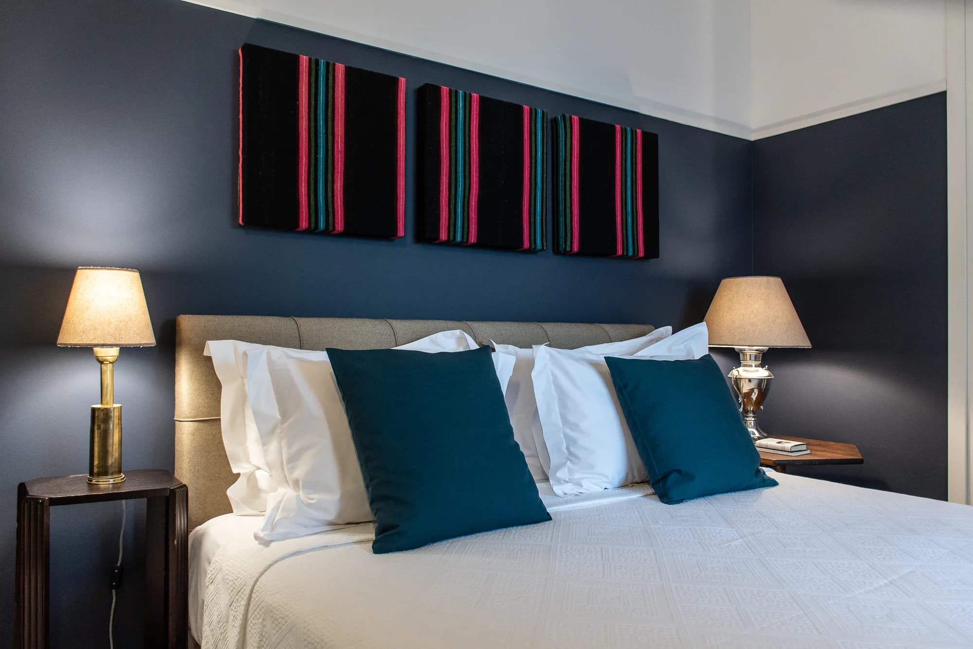 Bedroom with double bed, teal pillows, and bedside lamps at Rafter Koufonisia Galene in Koufonisia, Greece