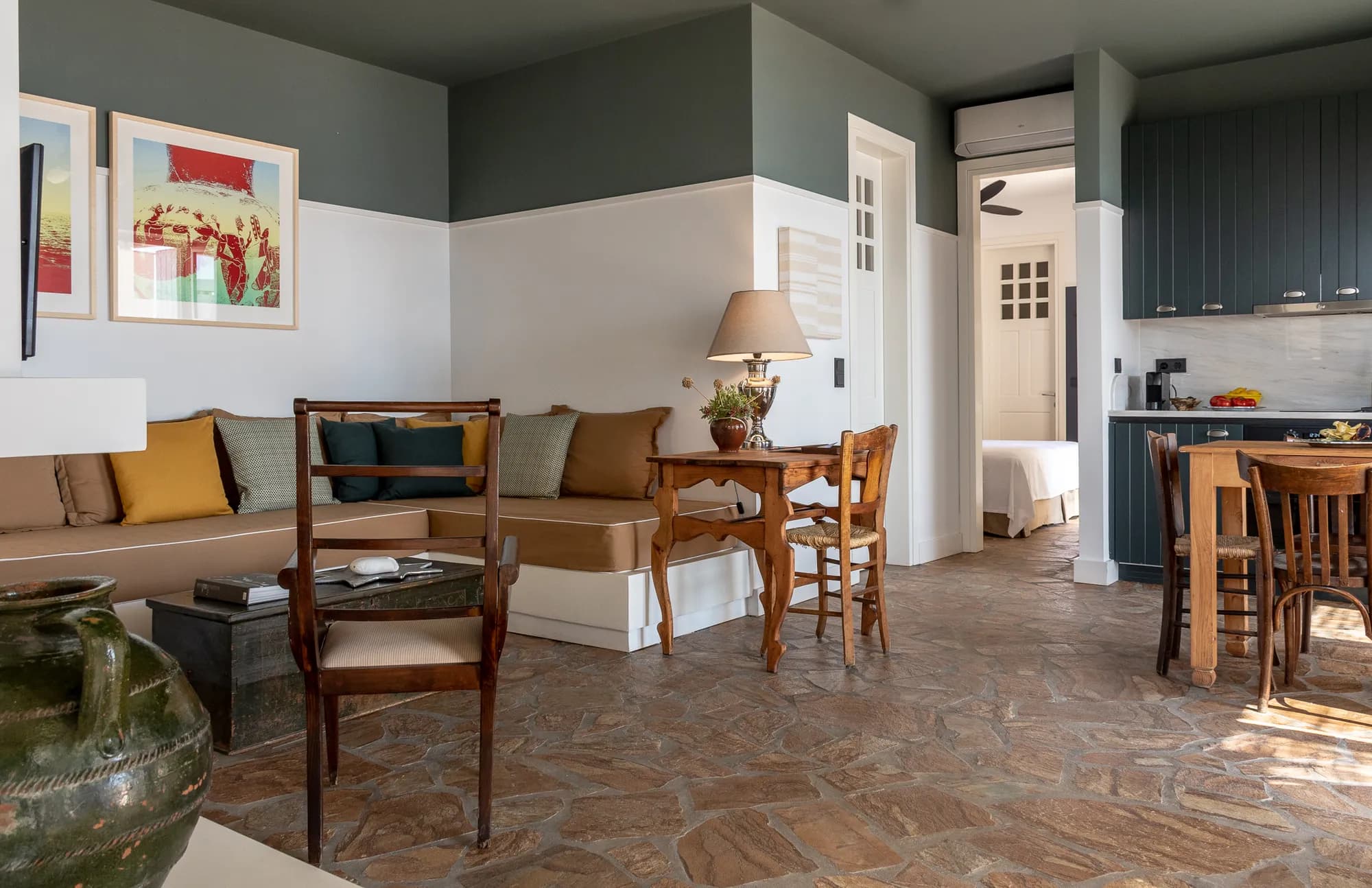 Living area with built-in seating, wooden furniture, and kitchen in Rafter Koufonisia Galene, Koufonisia, Greece