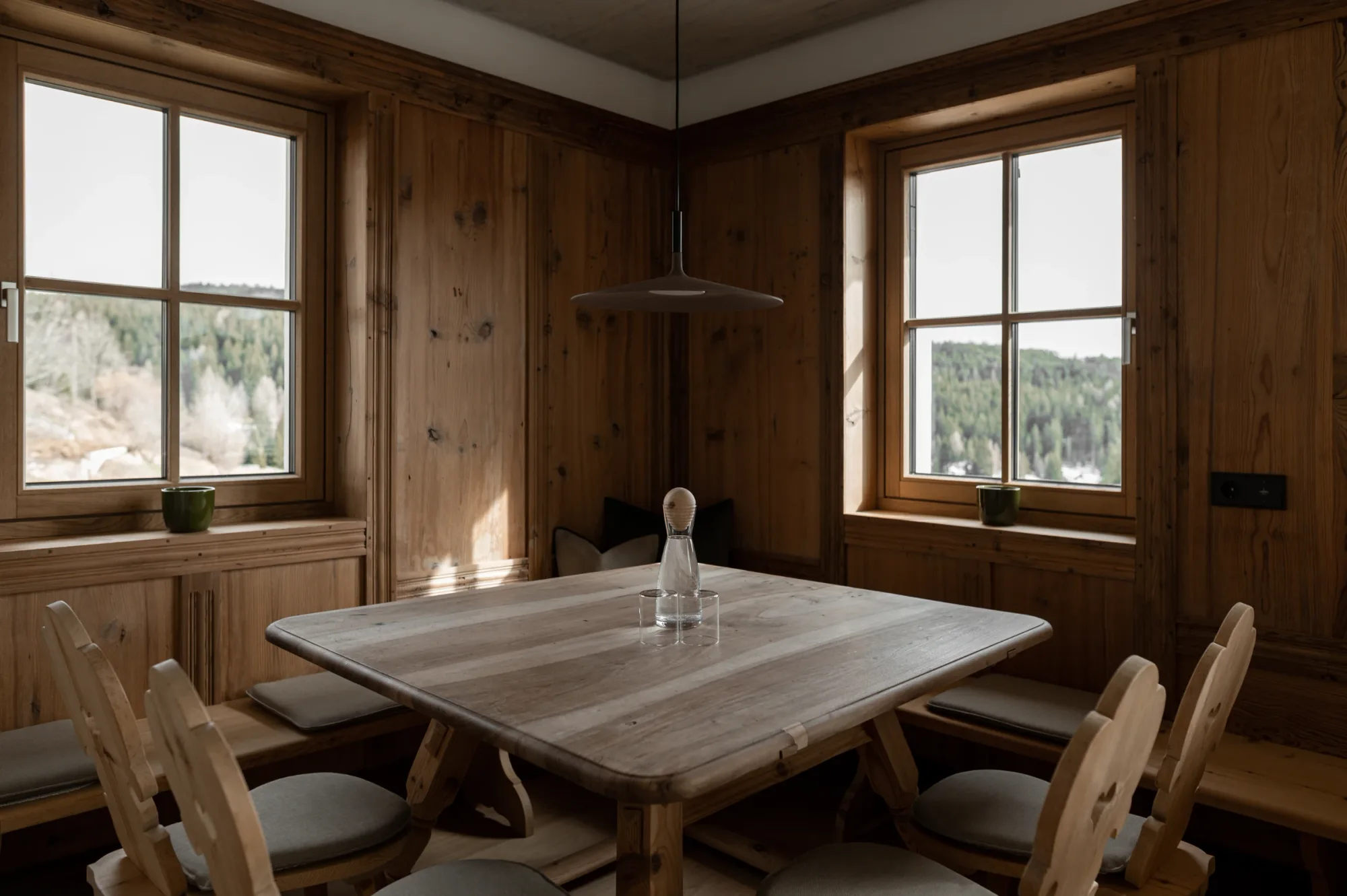 Wood-paneled dining room with forest views at Rafter Bolzano Oberinn in Oberinn, Italy