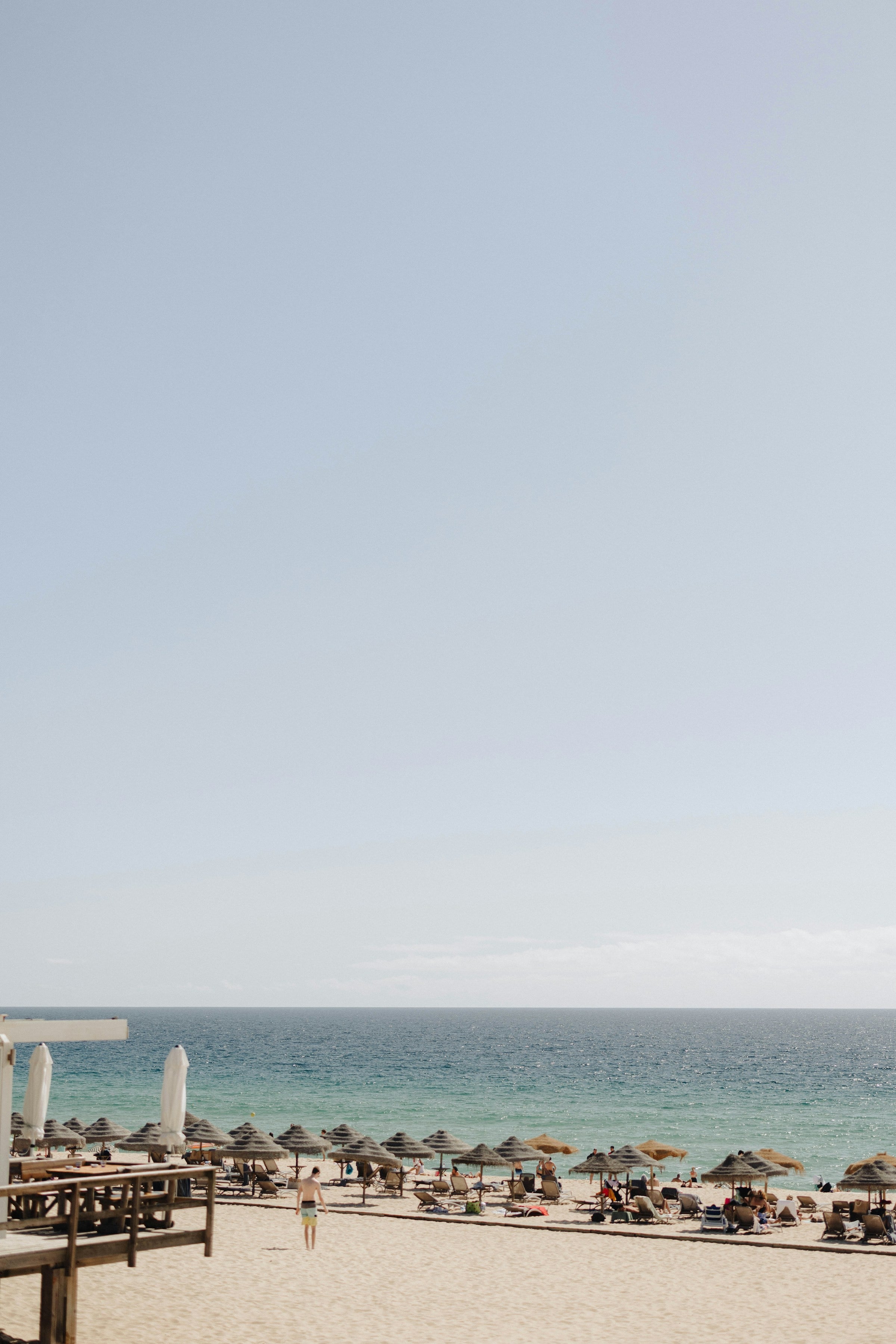 The beach of Melides with blue skies and sunbeds